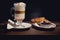 Glass of Latte macchiato with rich milk foam. Hot chocolate and coffee beverage with whipped cream and sweet cupcake and croissant