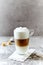 Glass of Latte Macchiato on stone background