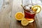 Glass of lemon iced tea with straw on rustic wood