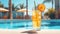 Glass of lemonade with ice on the background of the swimming pool.