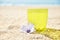 Glass of lemonade on sand, cocktail on beach