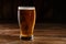 Glass of light beer on a dark pub. Glass beer on wood background with copy space