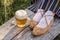 Glass of light beer and leather bast woman shoes