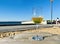 Glass with limonade wooden table  on the beach in sea port blue sky  sun beam reflection and  scene