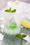 Glass made of ice with vodka, lemon and mint