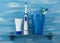 In glass are mechanical toothbrushes, next electric and toothpaste, on blue background