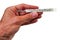 Glass mercury thermometer hold by male hand.