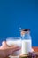 A glass of milk and bottle of milk on wooden table with blue background,healthy drink,high calcium.