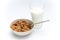 Glass of milk and bowl of brown cereals