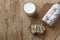 Glass of milk and cake with raisins on wooden desk