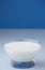 glass of milk for cereals, blue background