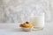 Glass of milk and cookies with gray wall grunge background.