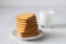 Glass of milk and cookies.stacks of tasty cookies on the white plate.