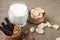 A glass of milk with cookies on a wooden board on a background sacking, burlap