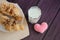 Glass of milk, croissants and felted hearts