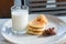 Glass of milk, Pancake and Chocolate cereal on white dish for br