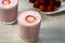 Glass of milk with strawberries close-up. Fresh strawberries in a glass of natural milk. Vitamin fruit cocktail. Diet breakfast