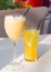 Glass of milkshake with marshmallow and orange limonade
