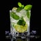 Glass of mojito cocktail with ice cubes mint and lime on black background.Generative AI