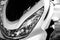 Glass motorcycle headlight. Graceful lines. Front view. Black and white photo