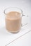 Glass mug of hot cocoa coffee drink