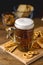 Glass Mug of Tasty Light Beer and Snacks on Wooden Table Pretzel Cracker with Solt Vertical