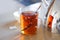Glass mug with tea, teapot en teabag on table