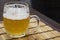 Glass mug of unfiltered weizen beer on table