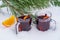 Glass with mulled red wine on a bed of snow and white background  close up. Christmas beverage