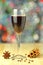 Glass of mulled spiced red wine on bokeh background