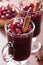 Glass of mulled wine with cranberry and spices, winter drink