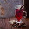 Glass of mulled wine on old wooden table