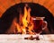 Glass of mulled wine over fireplace