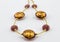 Glass - Murano gold and rose bead necklace close up on white background - Venice