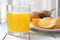 A glass of natural oranges served next to some slices