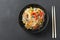 Glass noodle with vegetable in a black bowl on a grey background. Asian food Asian cuisine. Asian or Szechuan noodles