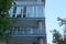 Glass open balcony on a gray building against the sky