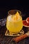 Glass of orange alcoholic drink with ice and slice of orange