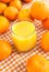 Glass of orange juice with some tangerines