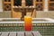 A glass of orange juice with syrup in a glass against the background of a Moroccan fountain