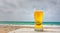 Glass of pale golden Pilsener beer at the seaside