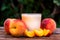 Glass of peach yoghurt and peaches on wooden table