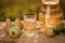 A glass with pear juice and basket with pears on wooden table with natural orchard background on sunset light. Vegetarian fruit