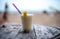 Glass of pinacolada on the table on the beach