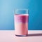 Glass of pink milkshake with blue background. AI-generated.