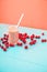 A glass of pink smoothies Berries of a sweet cherry on a blue background. Place for text