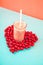 A glass of pink smoothies Berries of a sweet cherry on a blue background. Place for text