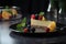 glass plate with beautiful slice of cheesecake, topped with fresh fruit and mint leaves