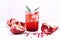 Glass of Pomegranate Juice with Ice and Fresh Pomegranate Fruits on White Backgroud Healthy Detox Drink