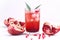 Glass of Pomegranate Juice with Ice and Fresh Pomegranate Fruits on White Backgroud Healthy Detox Drink